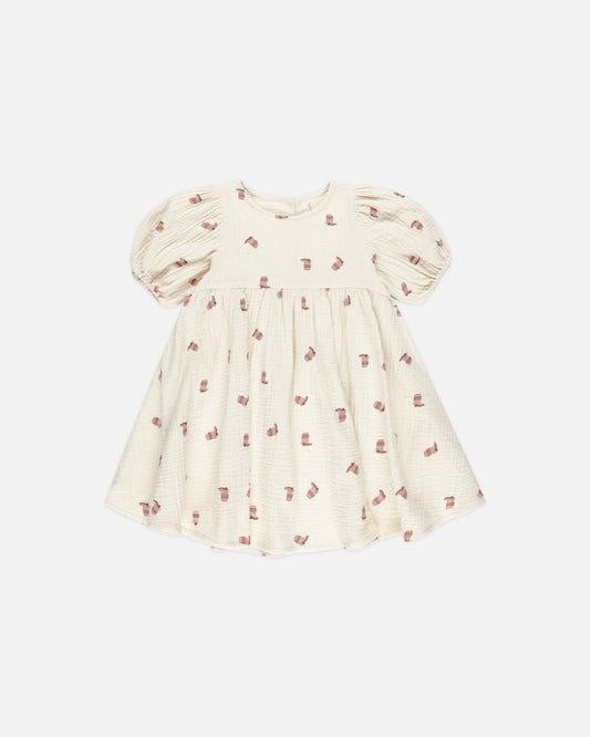 Cream-colored dress with puff sleeves and small red pattern on a white background